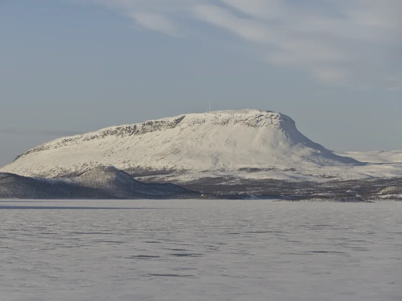 Saana fell under snow above the frozen Ala-Kilpisjärvi lake, in soft March light